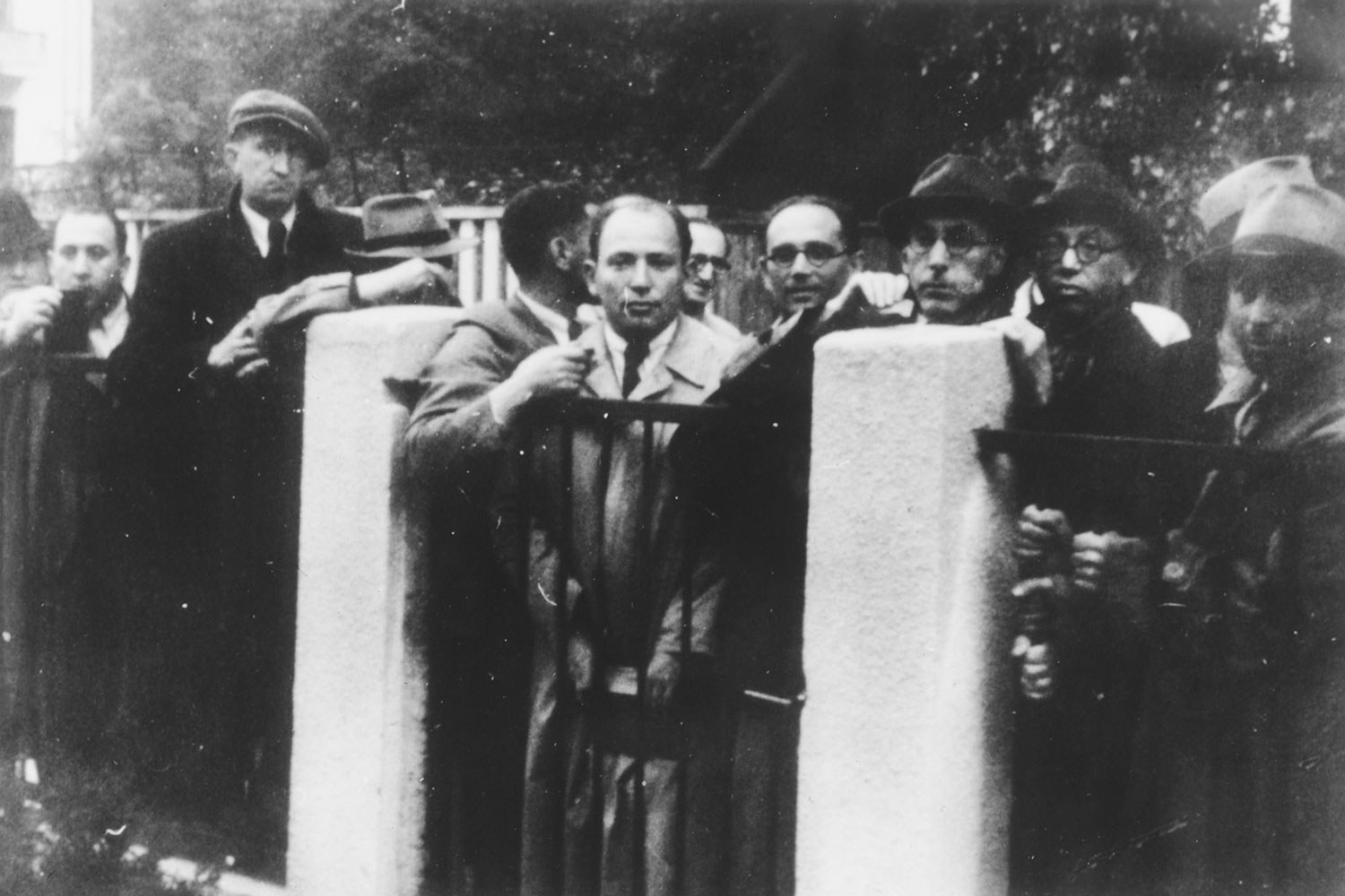 Jewish refugees crowded against the fence and gate posts of the Japanese consulate in Kaunas, Lithuania, waiting for transit visas, July 1940